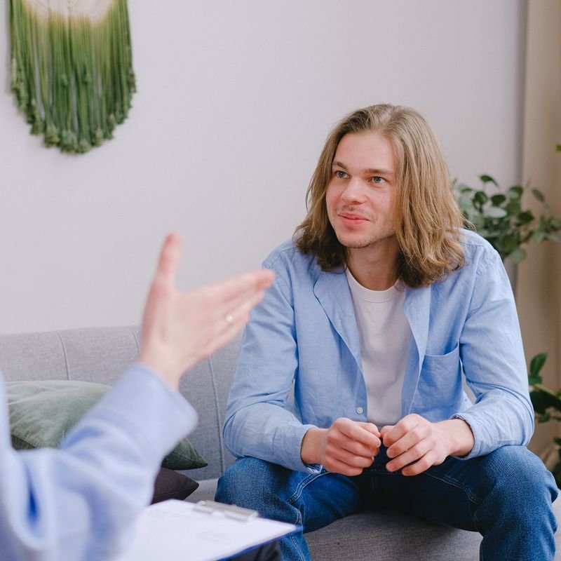 A young man talking openly during a supportive one-to-one session